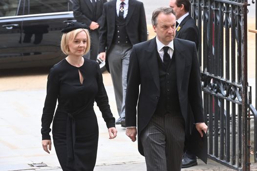 LONDON, ENGLAND - SEPTEMBER 19: British Prime Minister Liz Truss and husband Hugh O'Leary arrive for the State Funeral of Queen Elizabeth II at Westminster Abbey on September 19, 2022 in London, England. Elizabeth Alexandra Mary Windsor was born in Bruton Street, Mayfair, London on 21 April 1926. She married Prince Philip in 1947 and ascended the throne of the United Kingdom and Commonwealth on 6 February 1952 after the death of her Father, King George VI. Queen Elizabeth II died at Balmoral Castle in Scotland on September 8, 2022, and is succeeded by her eldest son, King Charles III. (Photo by Geoff Pugh - WPA Pool/Getty Images)