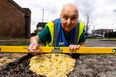 Man fills potholes with pot noodles to highlight state of UK roads
