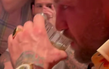 Fans concerned about Conor McGregor as he swigs whiskey and waves around $100 bills