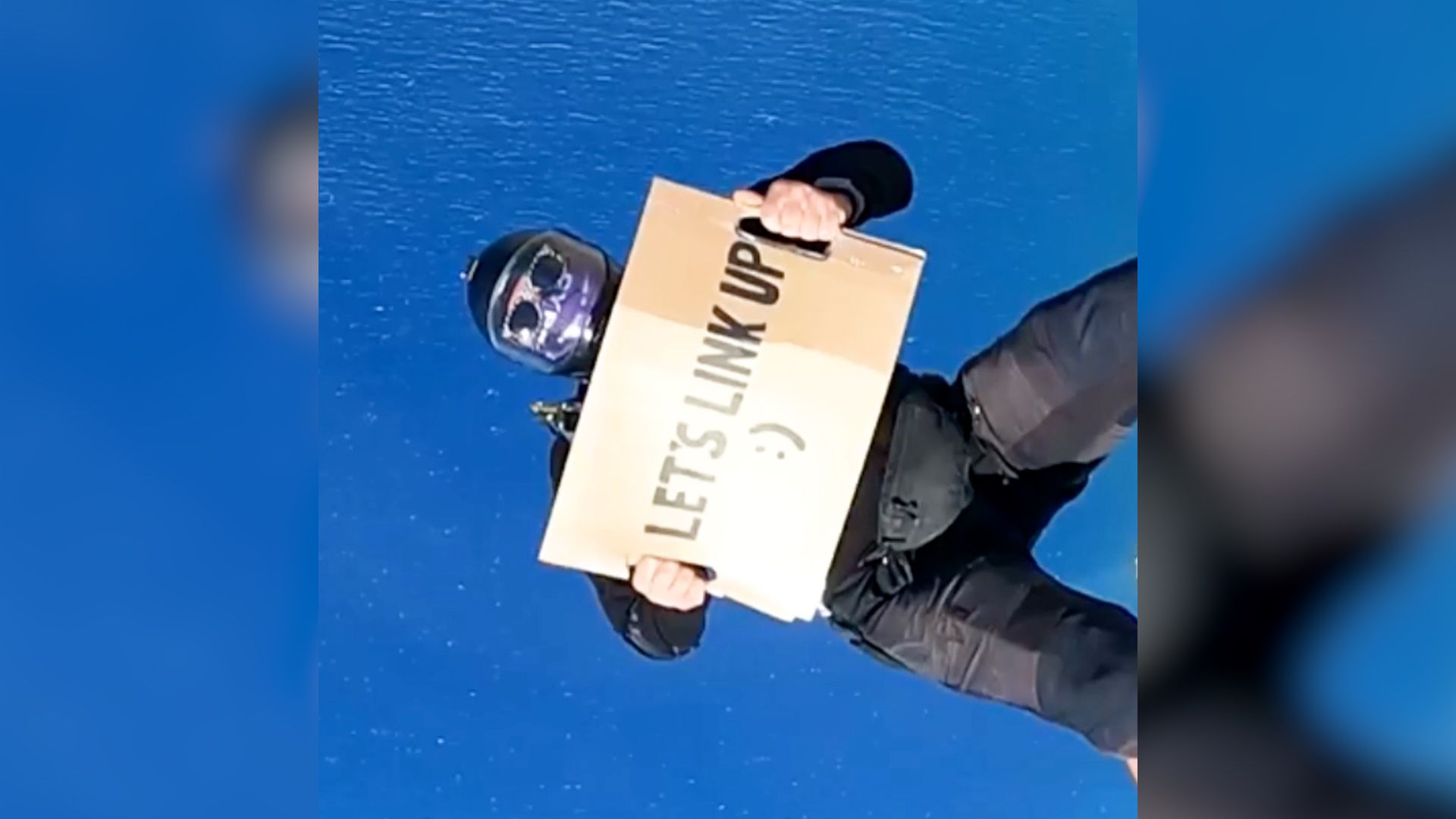 Job seeker lands dream role after jumping out of a plane with a cardboard sign asking for work