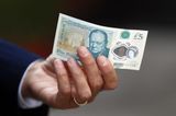 Bags of cash fall from security truck with dozens of people picking up £225,000