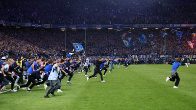 Huge pitch invasion sees 25 fans rushed to hospital