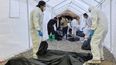 Almost 400 human bodies found piled high in neglected compound