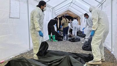 Almost 400 human bodies found piled high in neglected compound