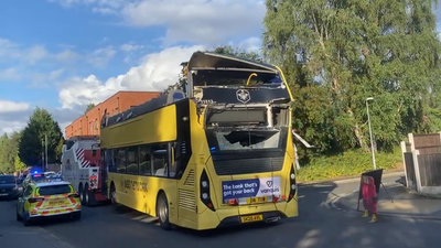 Bus driver arrested after 20 people injured as double-decker’s roof torn off